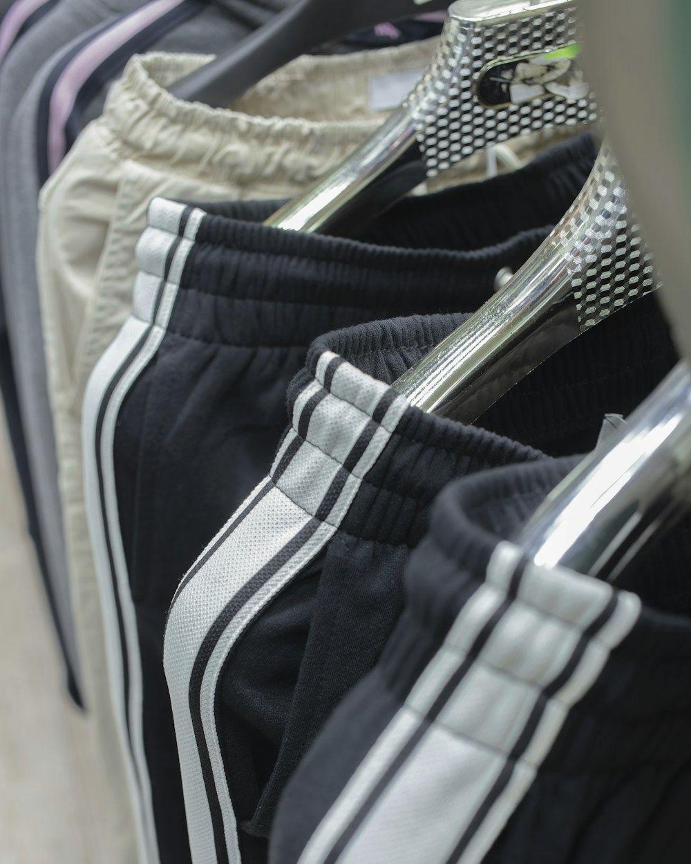 Track pants with side stripes on hangers