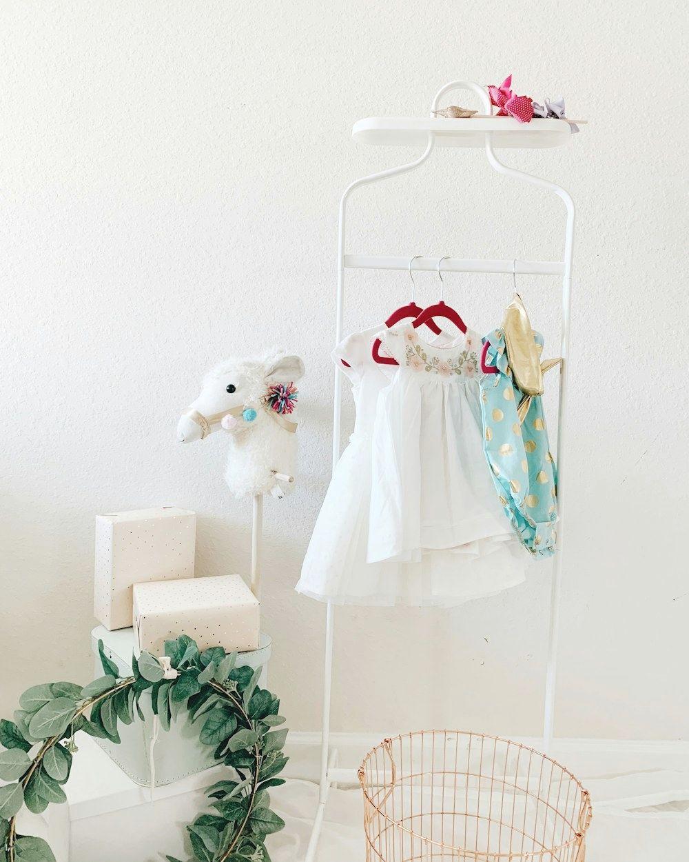 Baby clothes on a white clothing rack