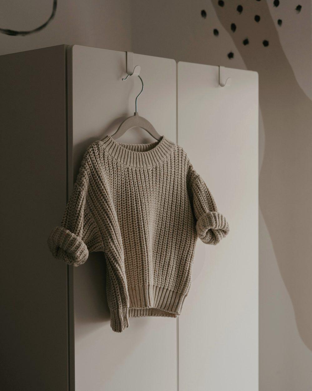 Chunky knit sweater on a hanger