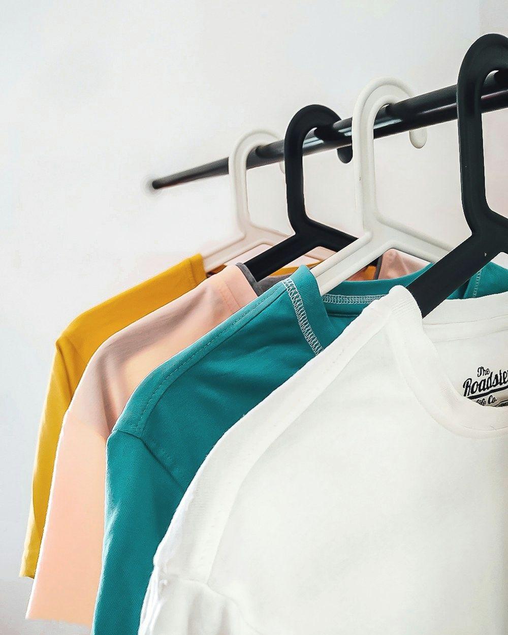 Colorful t-shirts on hangers